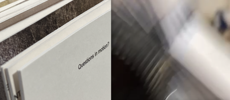 'questions in motion' typed on a card with blur