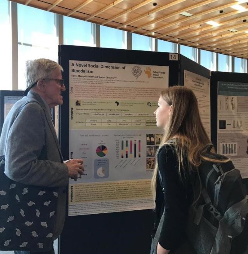 recent human sciences graduate kerris chappell smith discusses her poster with world renowned paleoanthropologist bernard wood