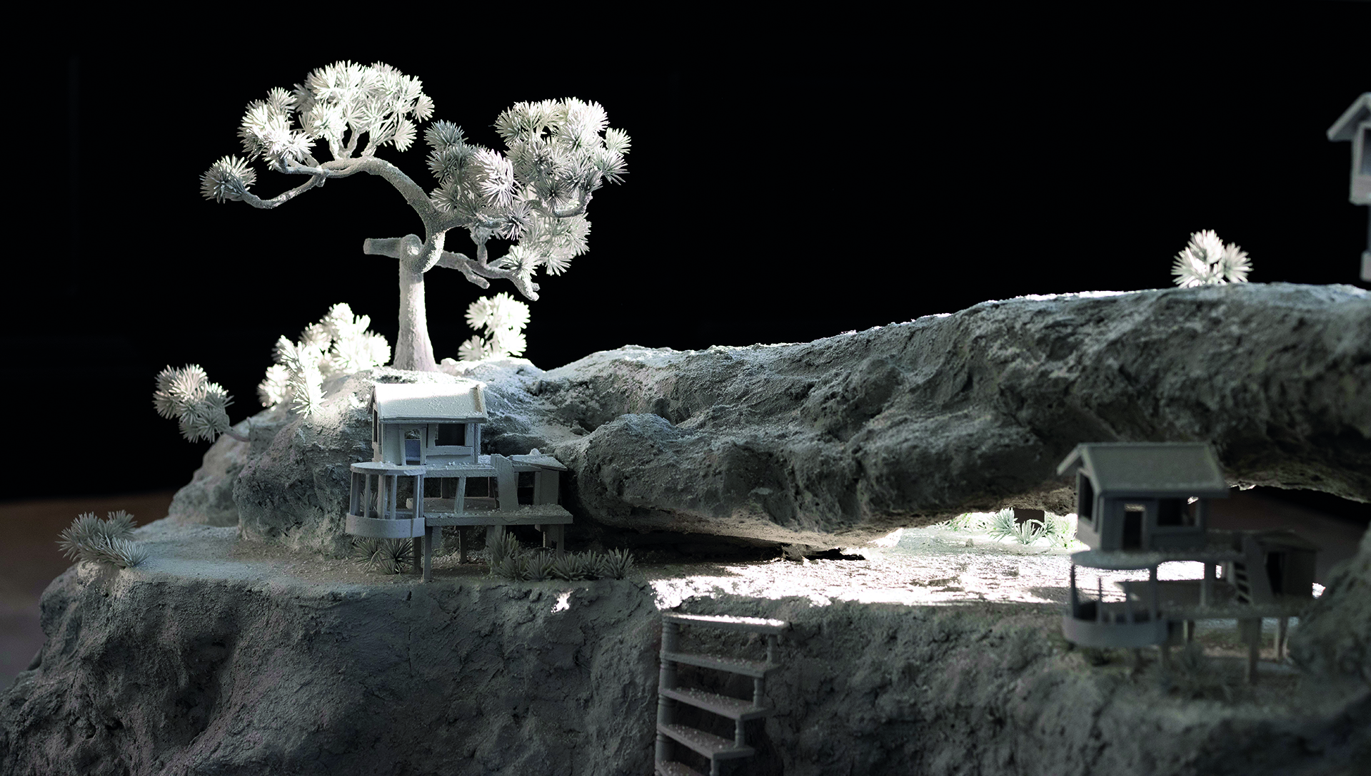 A white sculptural landscape showing minature buildings and trees