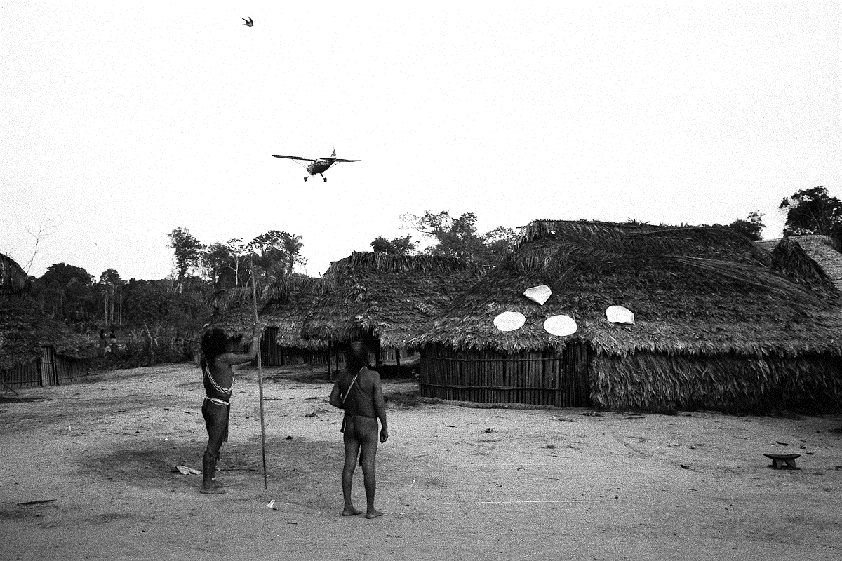 copyright prm trio of men watching a missionary aircraft