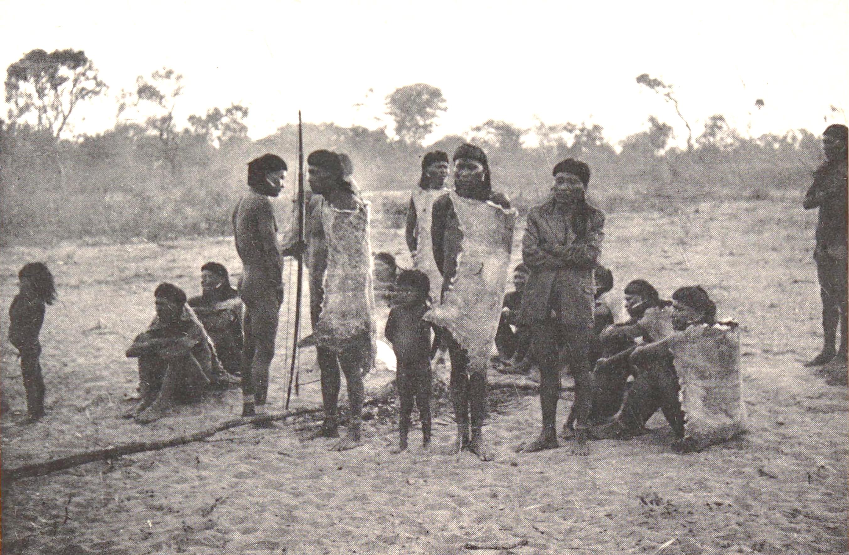 A black and white photo of a group of adults and children