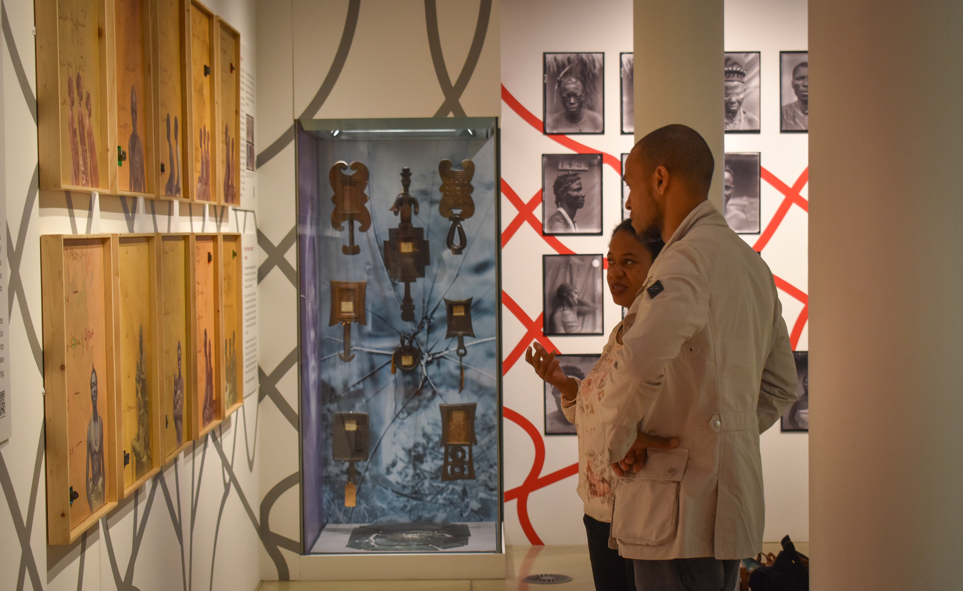 a man and a woman looking at exhibition together