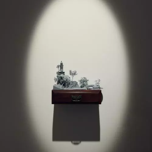 A sculpture of an imagined landscape in a wall mounted drawer
