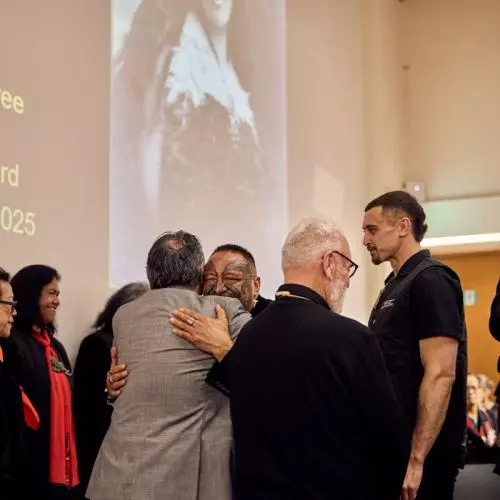 Representatives of Mākereti's tribe share warm hugs after the Māori remembrance ceremony. 