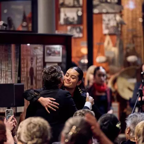 One of Mākereti's family members giving a warm hug to Professor Irene Tracy, Vice-Chancellor of the University of Oxford. 