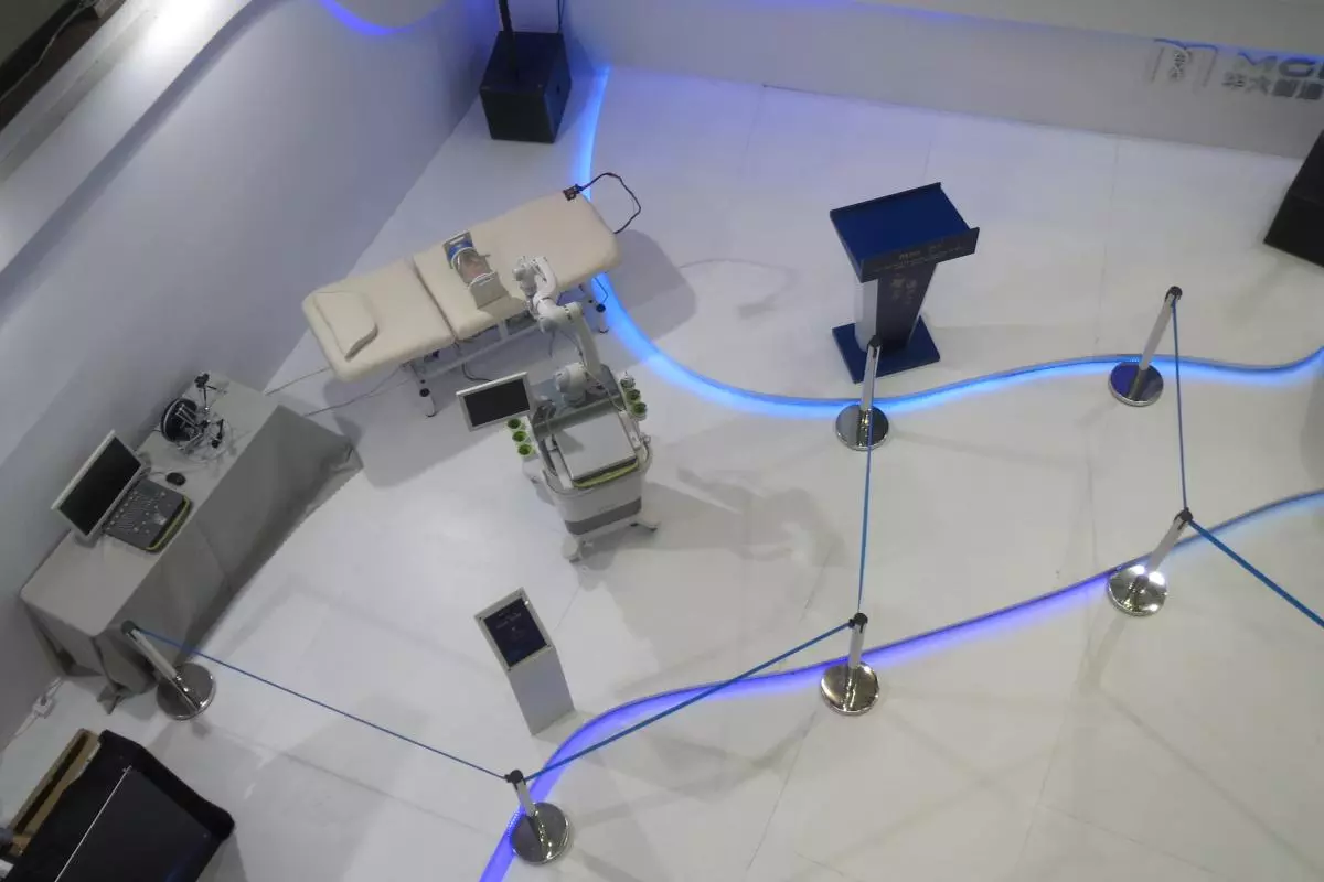A futurisic looking hospital bed displayed next to a lecturn